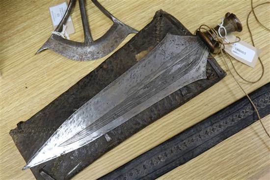 A Songye style ceremonial axe, the wooden handle covered in snakeskin, a Ngala style tribal knife and an Indian long sword,